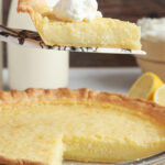 slice of Southern Buttermilk Pie being removed from pan