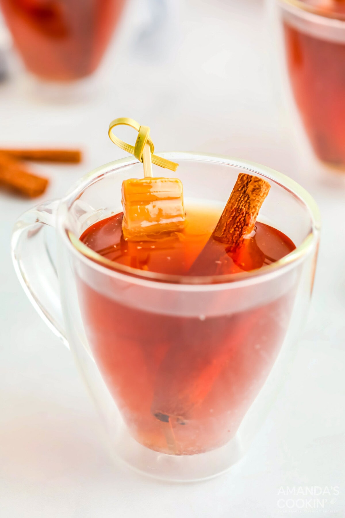 Spiked Caramel Apple Cider with cinnamon stick
