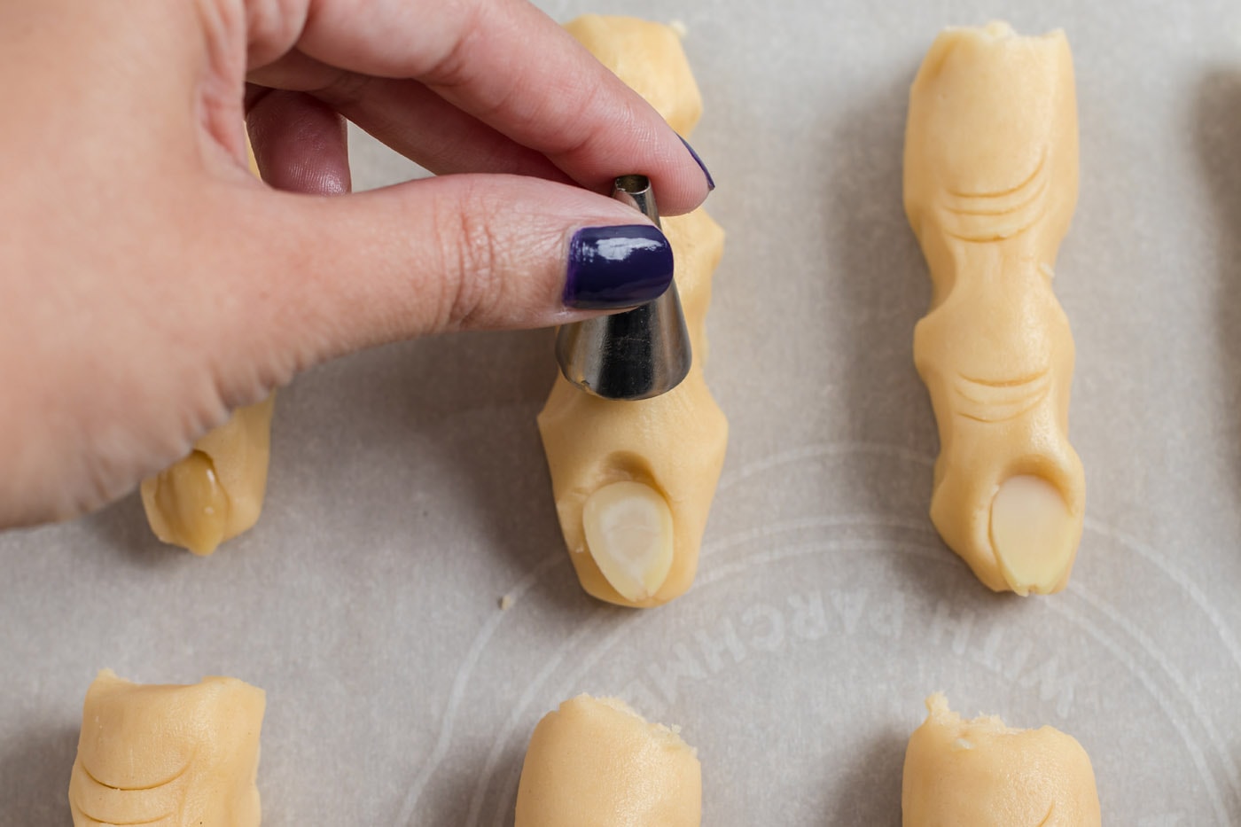 piping tip making indents in cookie dough