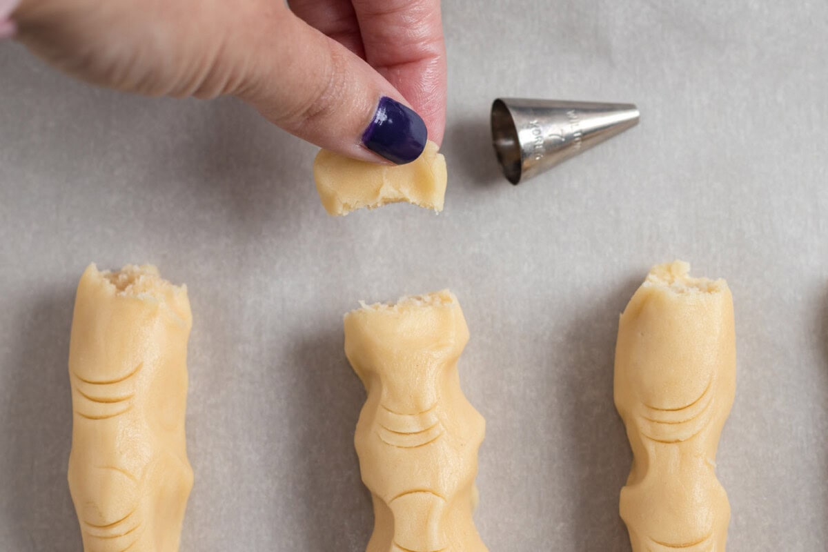 breaking off end of witch finger cookie dough