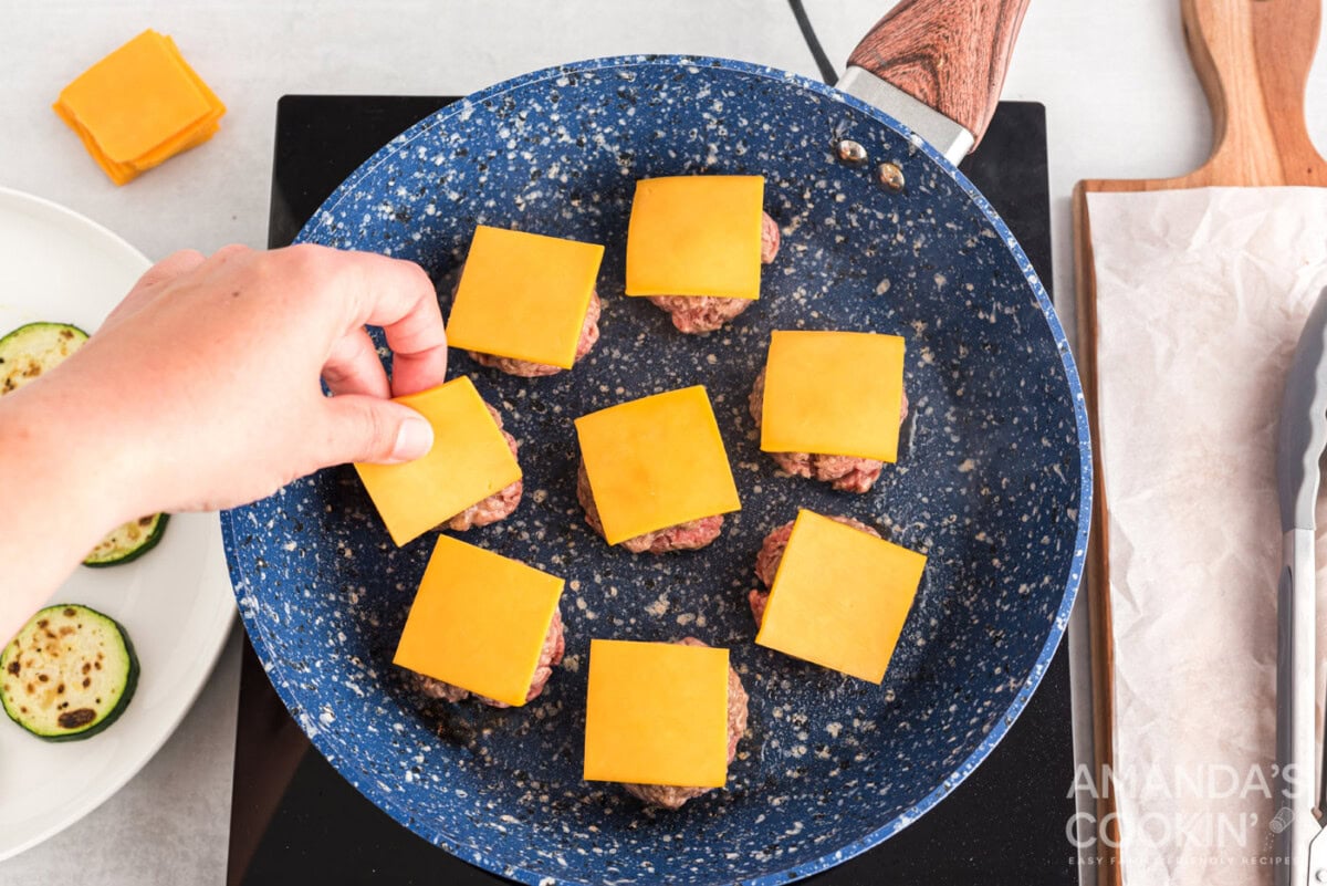 mini cheeseburgers in a skillet