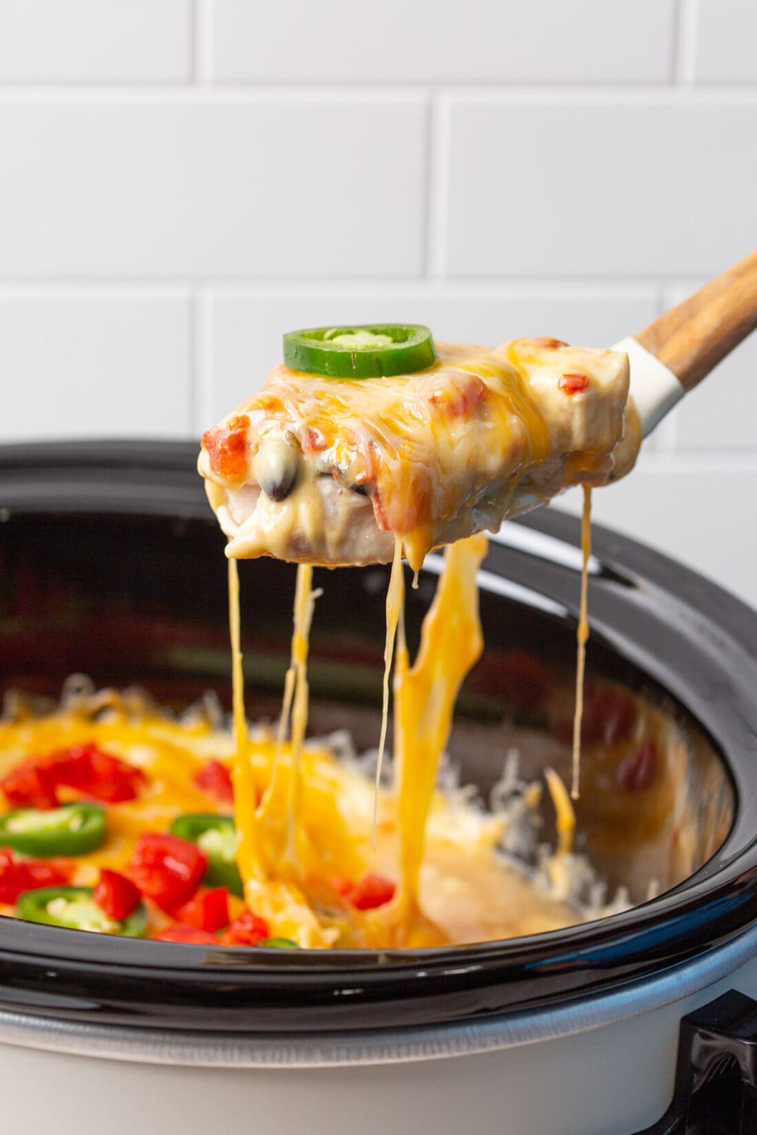 spoon lifting mexican chicken from crockpot