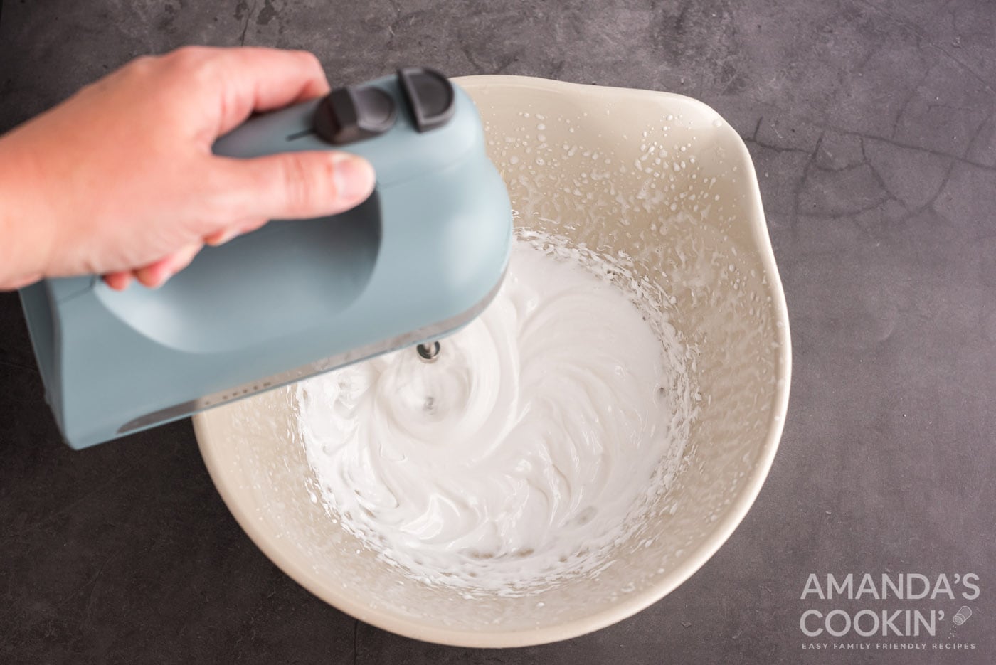 hand mixer mixing marshmallow in a bowl