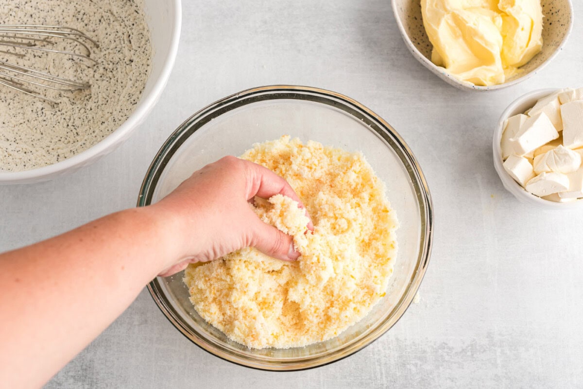 hand blending sugar and orange zest in a bowl