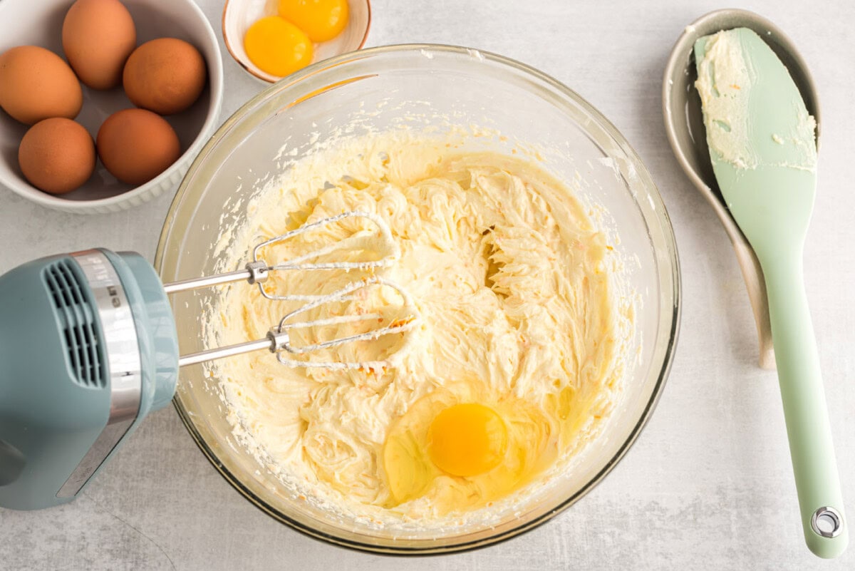 eggs in a bowl of orange poppy seed pound cake batter