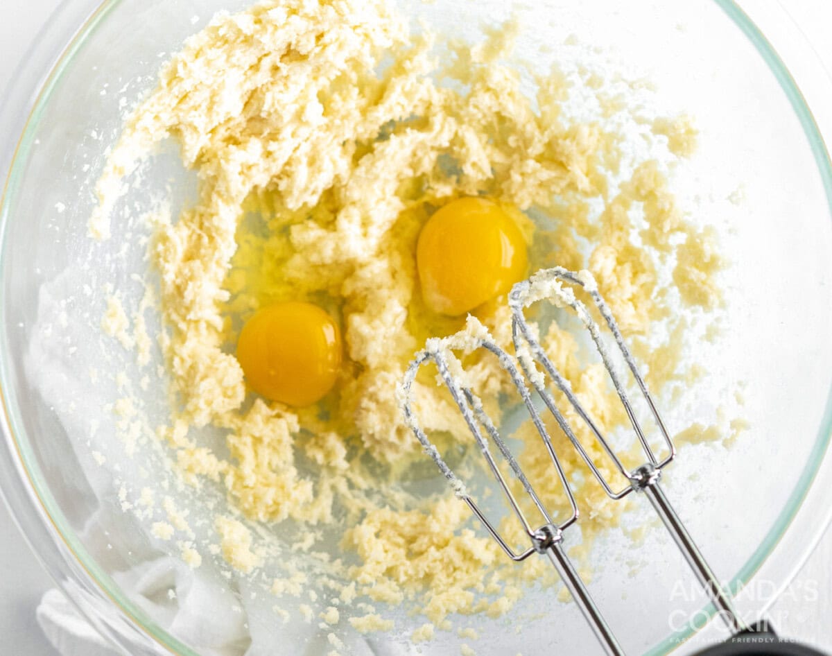 hand mixer beating eggs into batter
