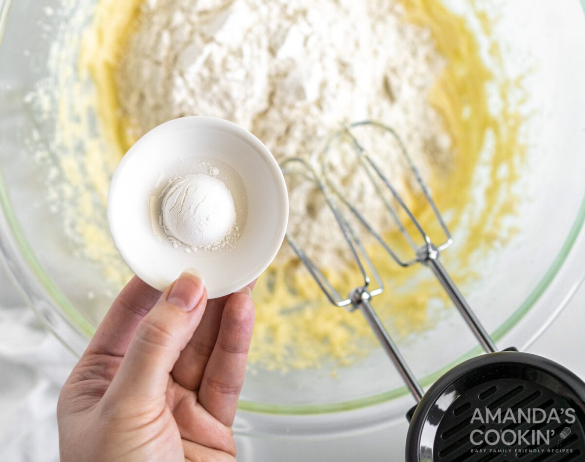 baking powder in a bowl over pound cake mix