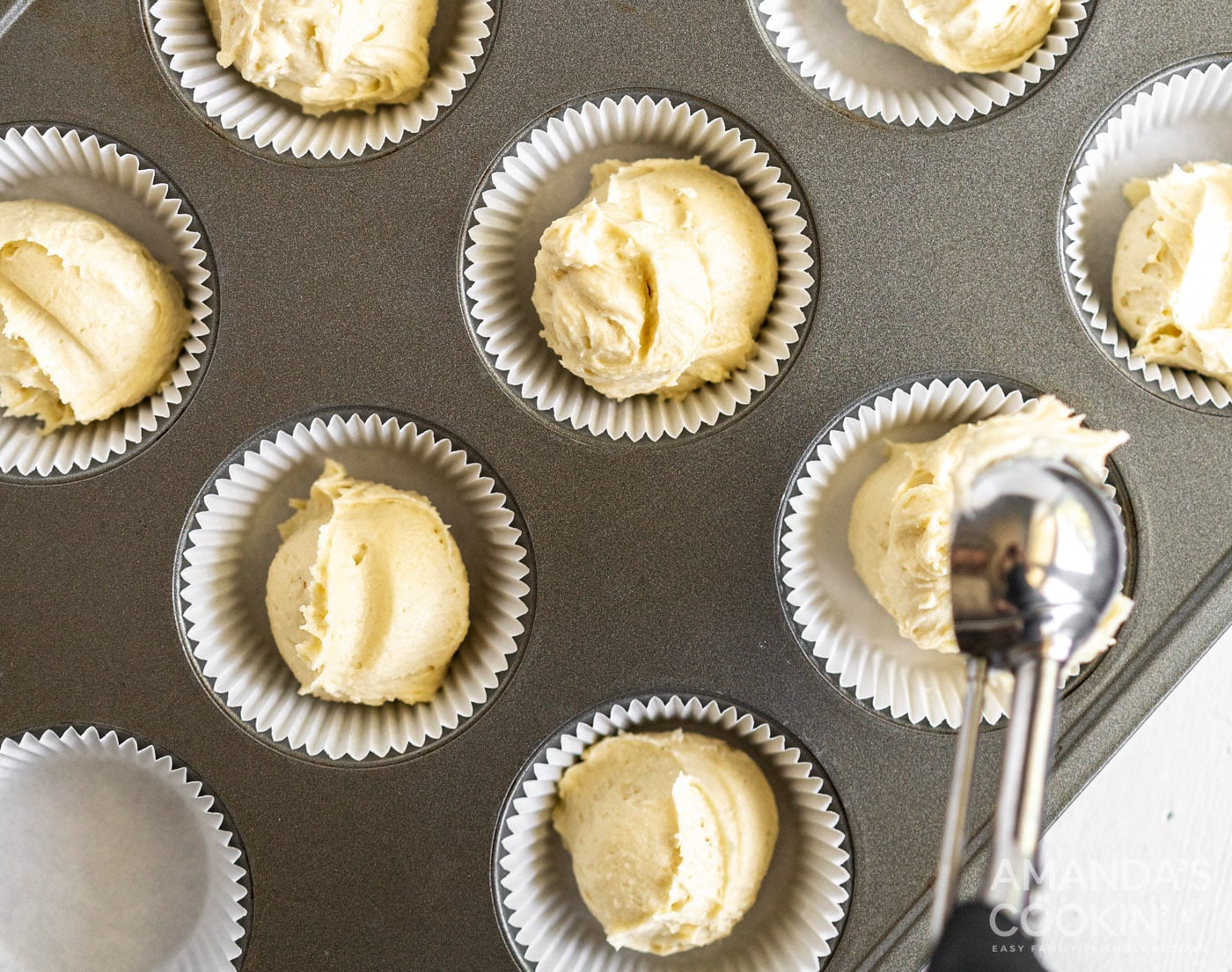 pound cake batter spooned into muffin tin