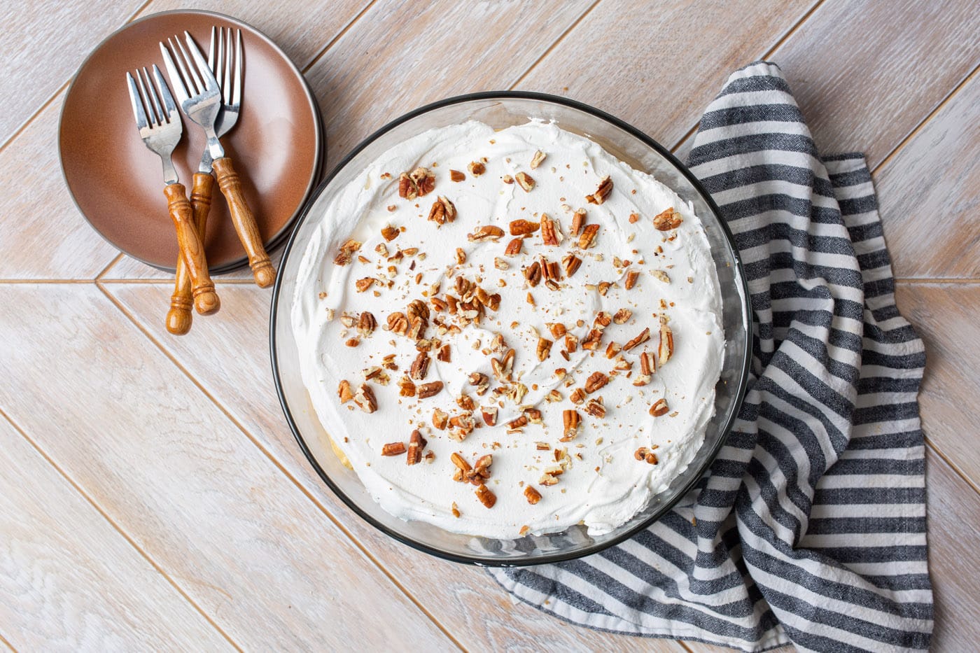 pecans on top of whipped topping in pumpkin trifle
