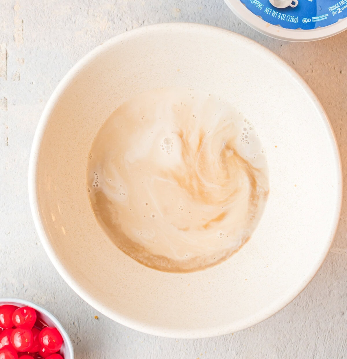 root beer, root beer flavoring, and heavy whipping cream in a bowl