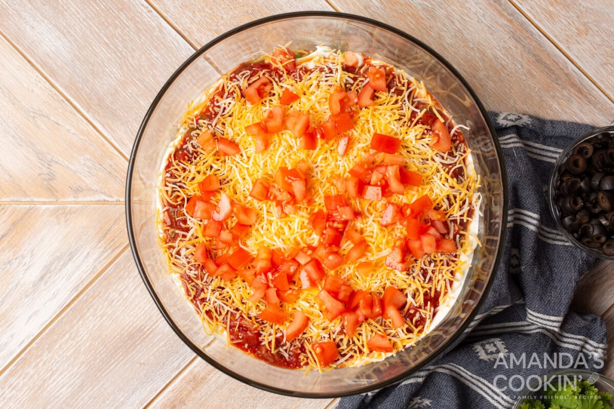 tomatoes on top of cheese in a bowl