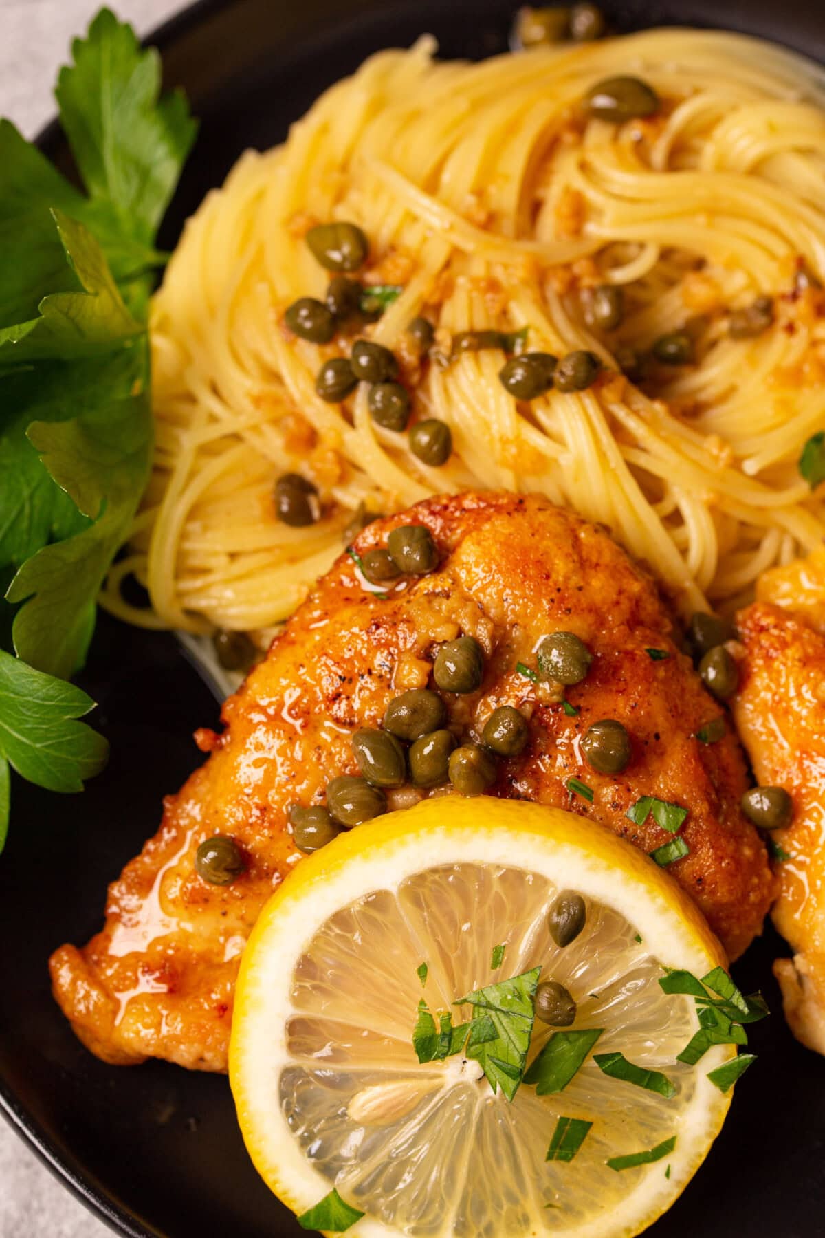 close up of Chicken Piccata with spaghetti