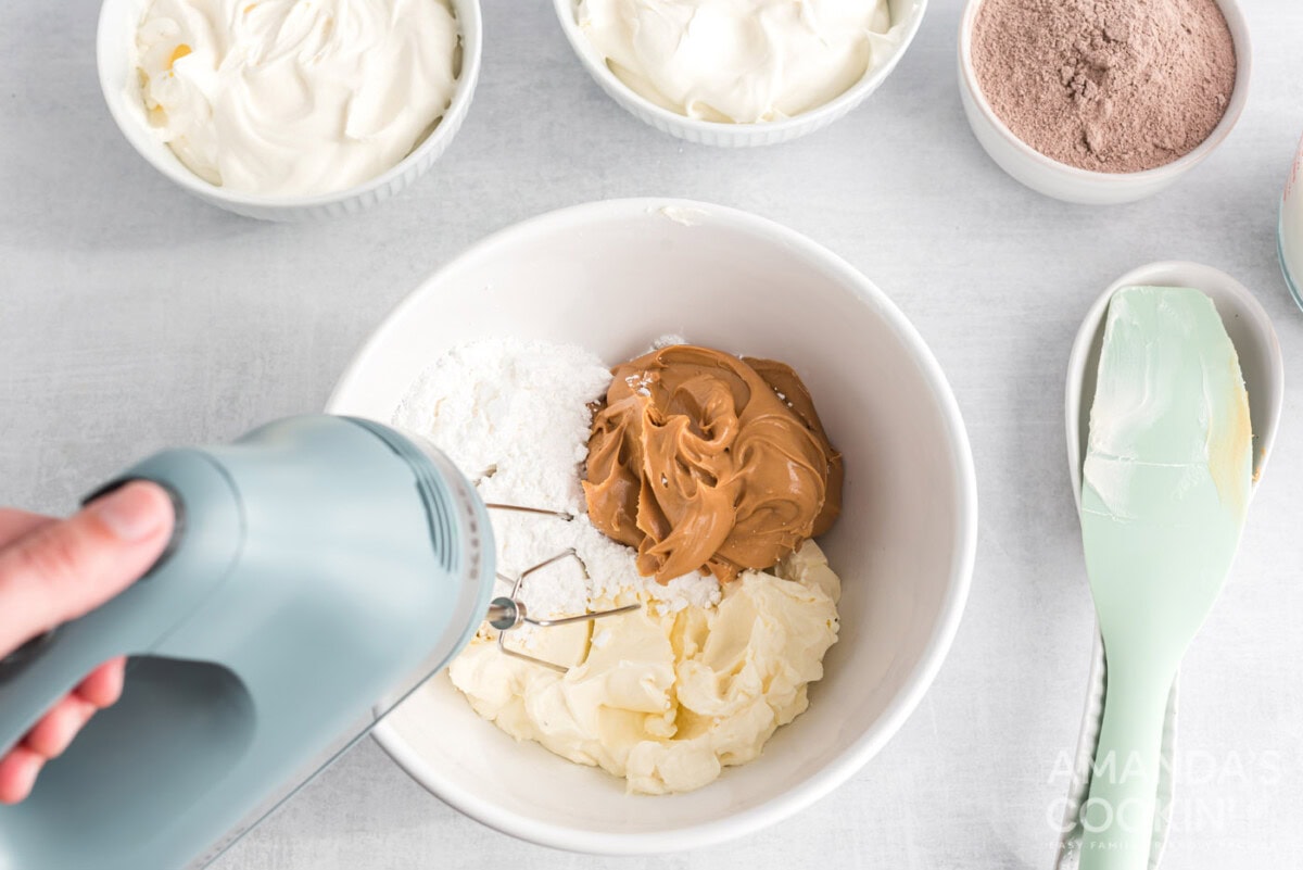 mixing peanut butter, powdered sugar and cream cheese in a bowl