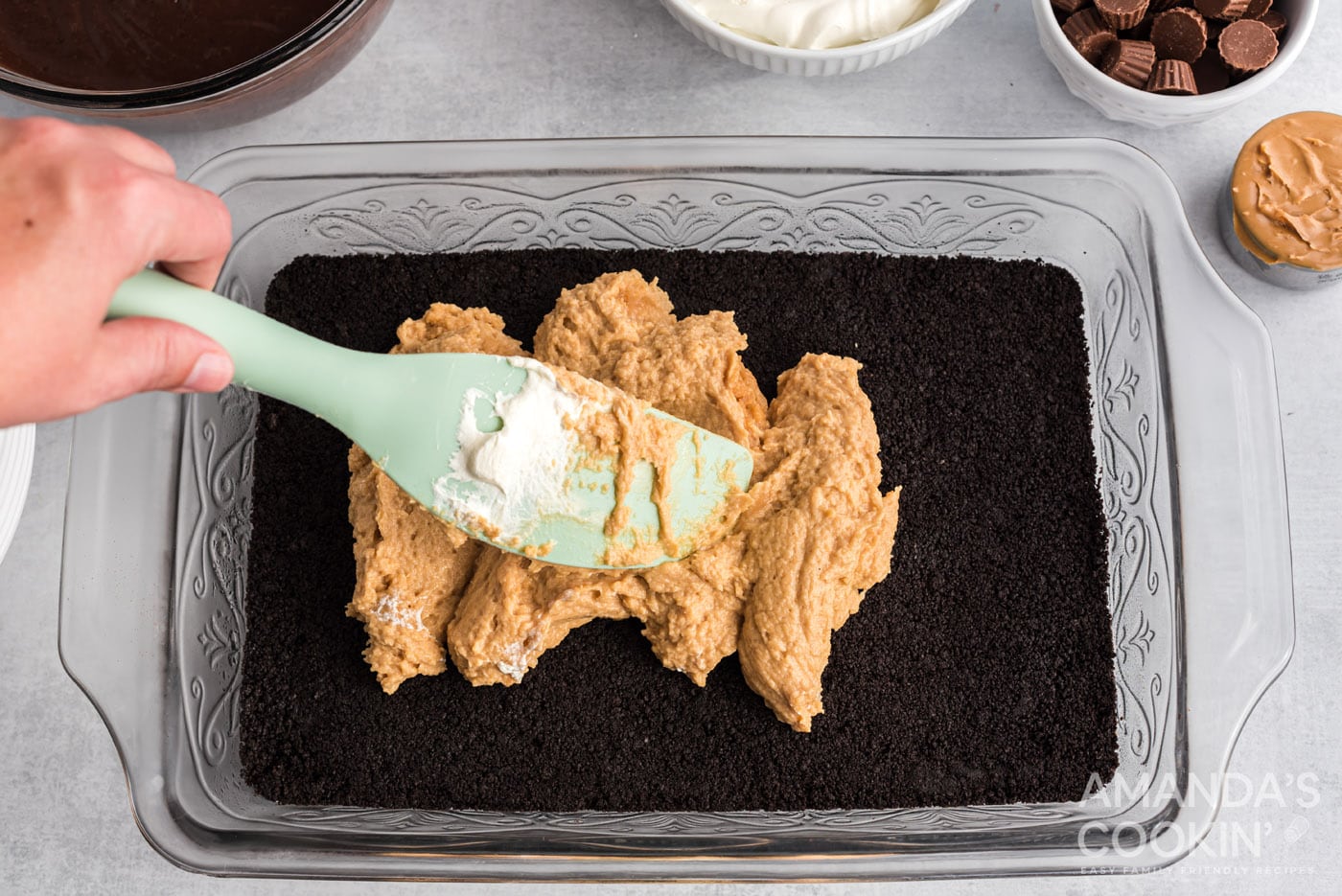 rubber spatula spreading out cream cheese peanut butter mixture