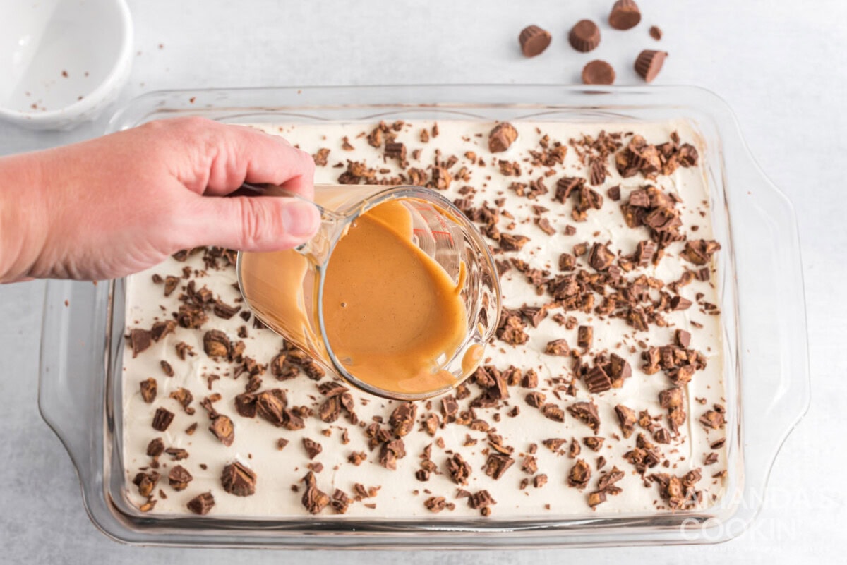 melted peanut butter on top of chocolate peanut butter lasagna