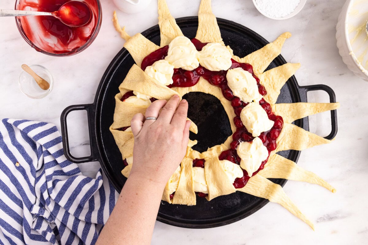 hand overlapping crescent rolls