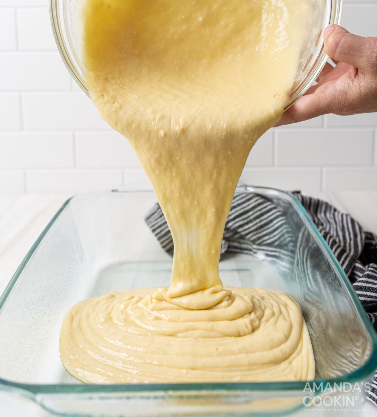 pouring cake batter into pan