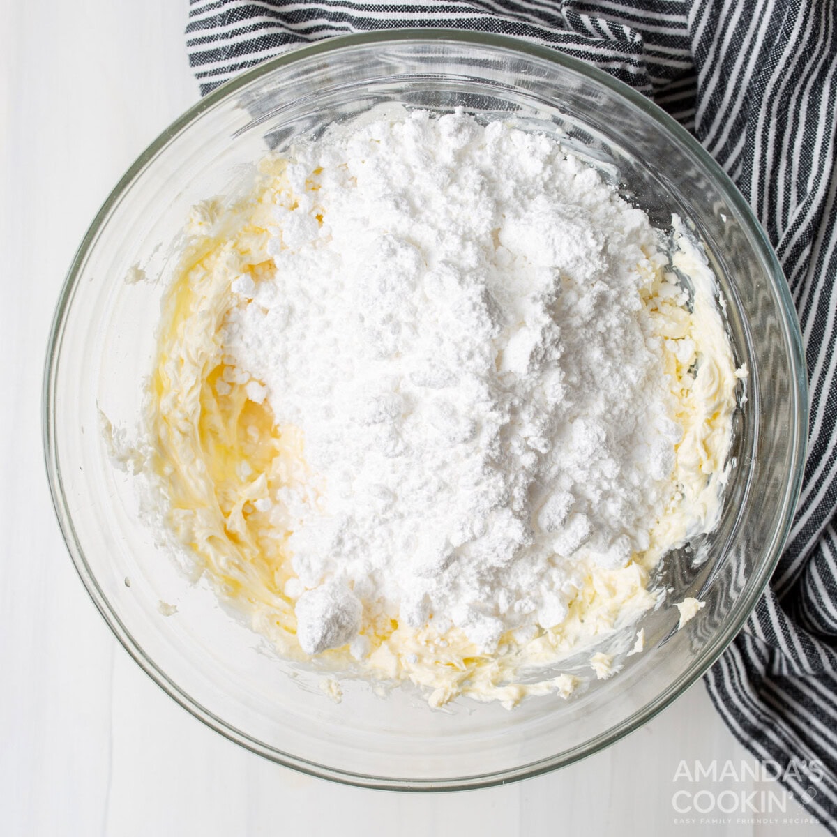 cream cheese and butter with  powdered sugar in a bowl