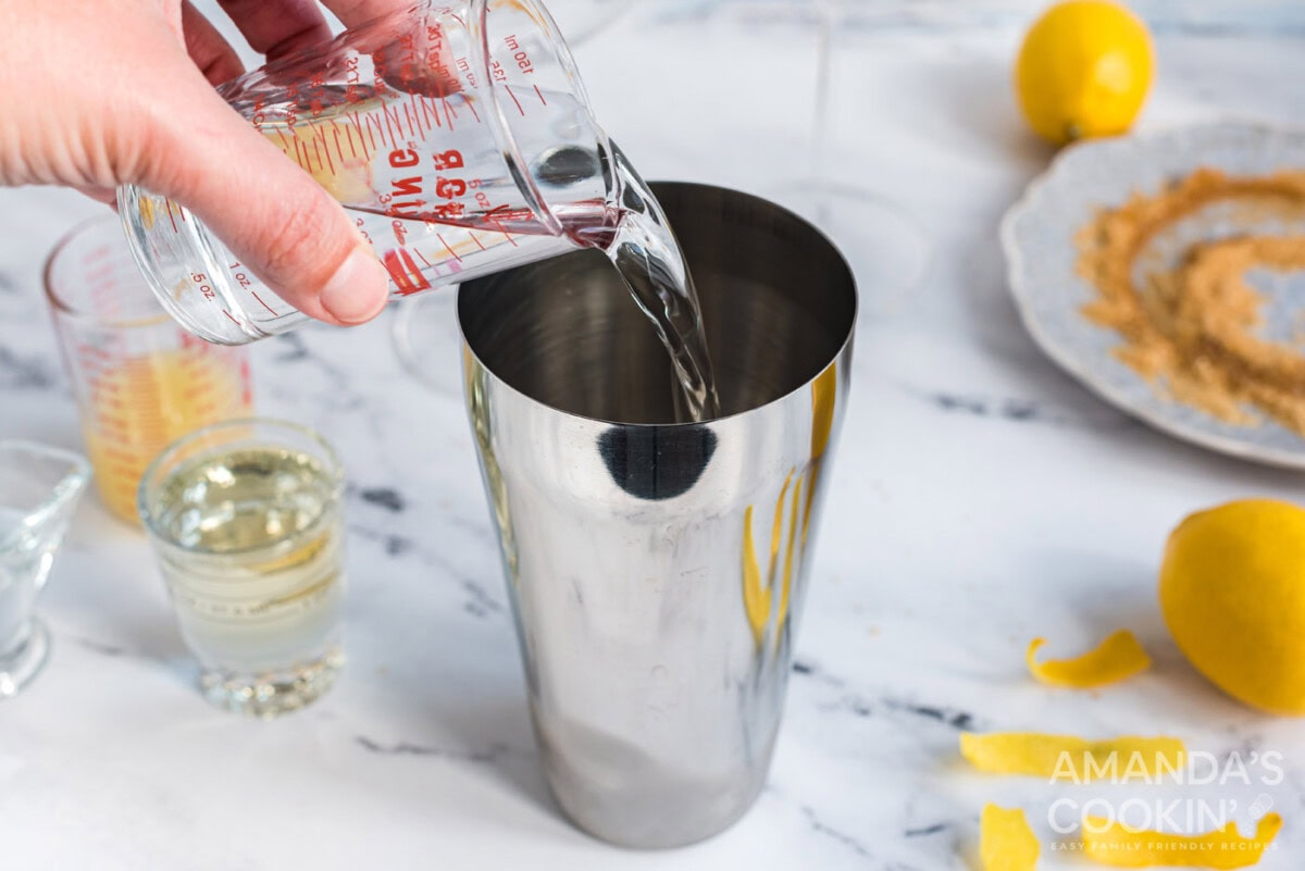 pouring vodka into cocktail shaker