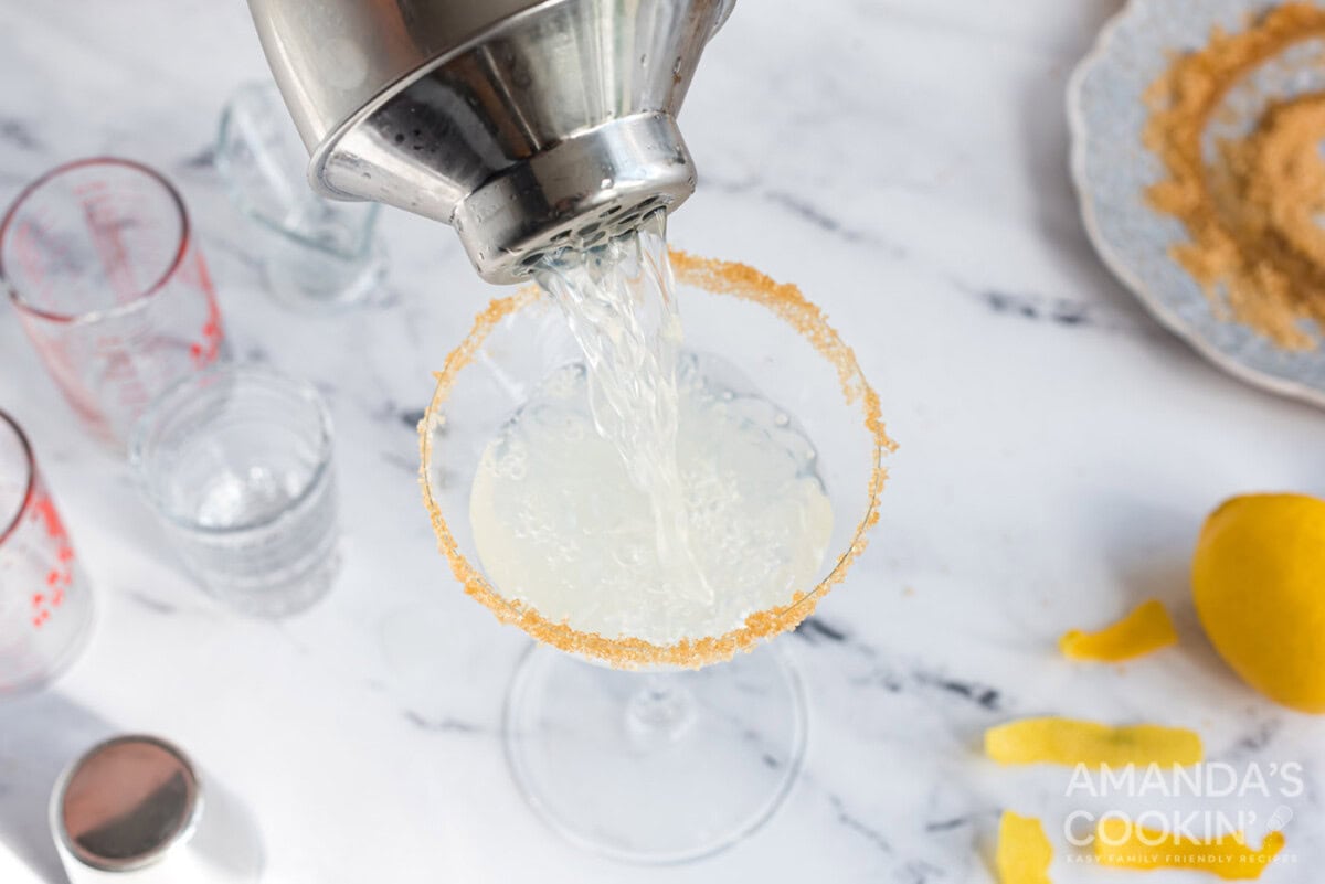 cocktail shaker pouring into martini glass