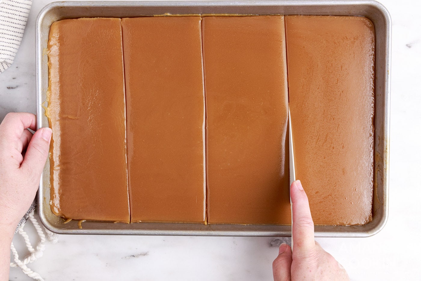 slicing caramel on a sheet pan