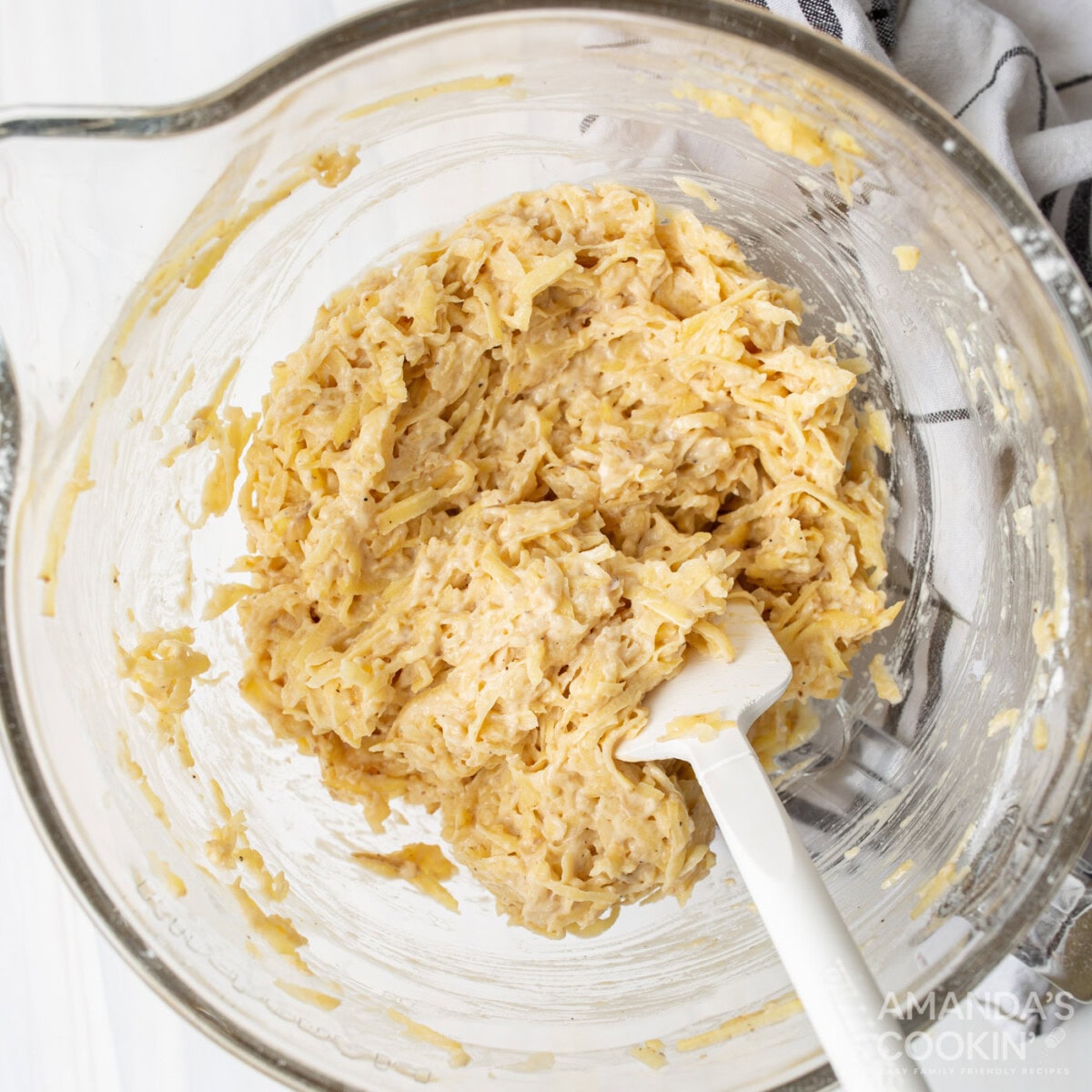potato, onion, flour, egg, and seasoning mixed in a bowl