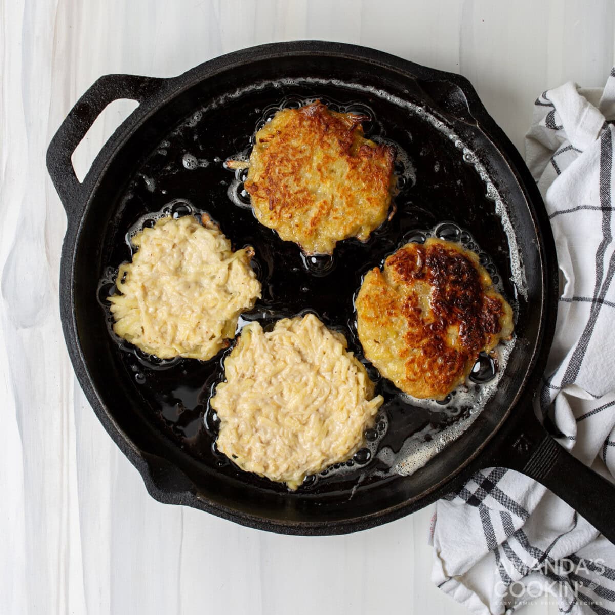 potato pancake patties frying in a pan