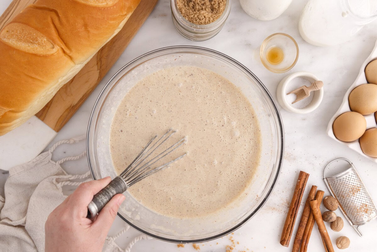 bread pudding cream mixture whisked in a bowl