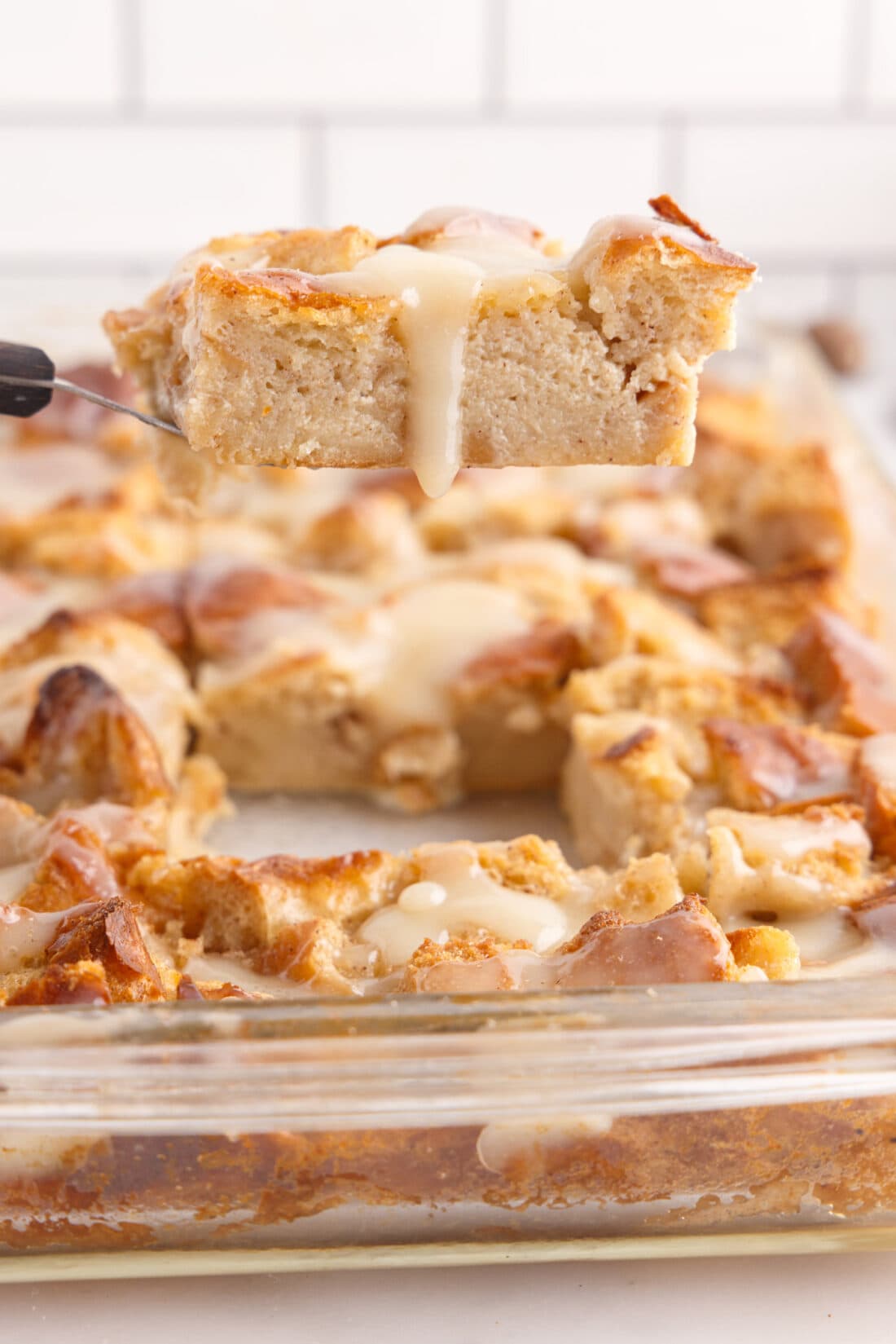 lifting a slice of Bread Pudding