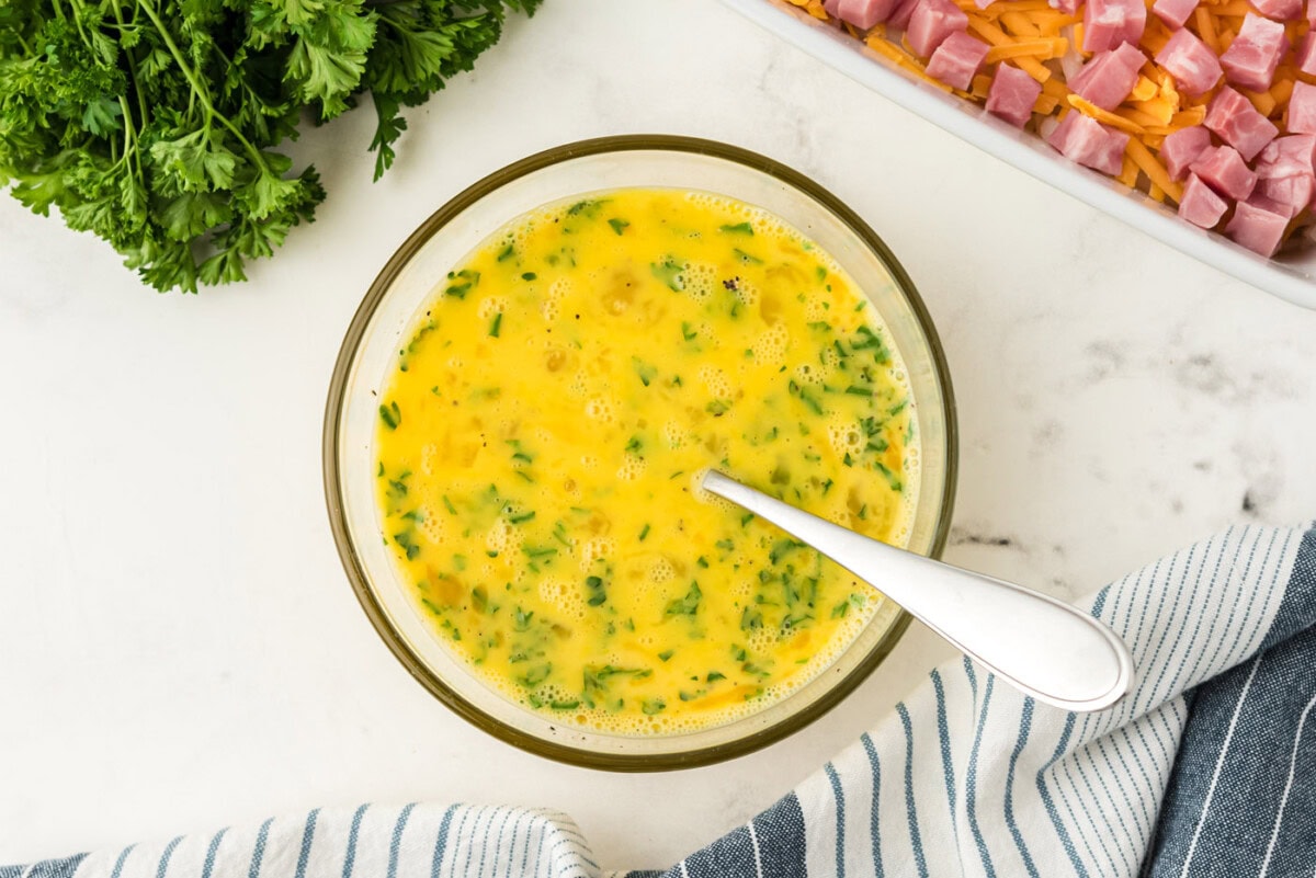egg and parsley mixed in a bowl