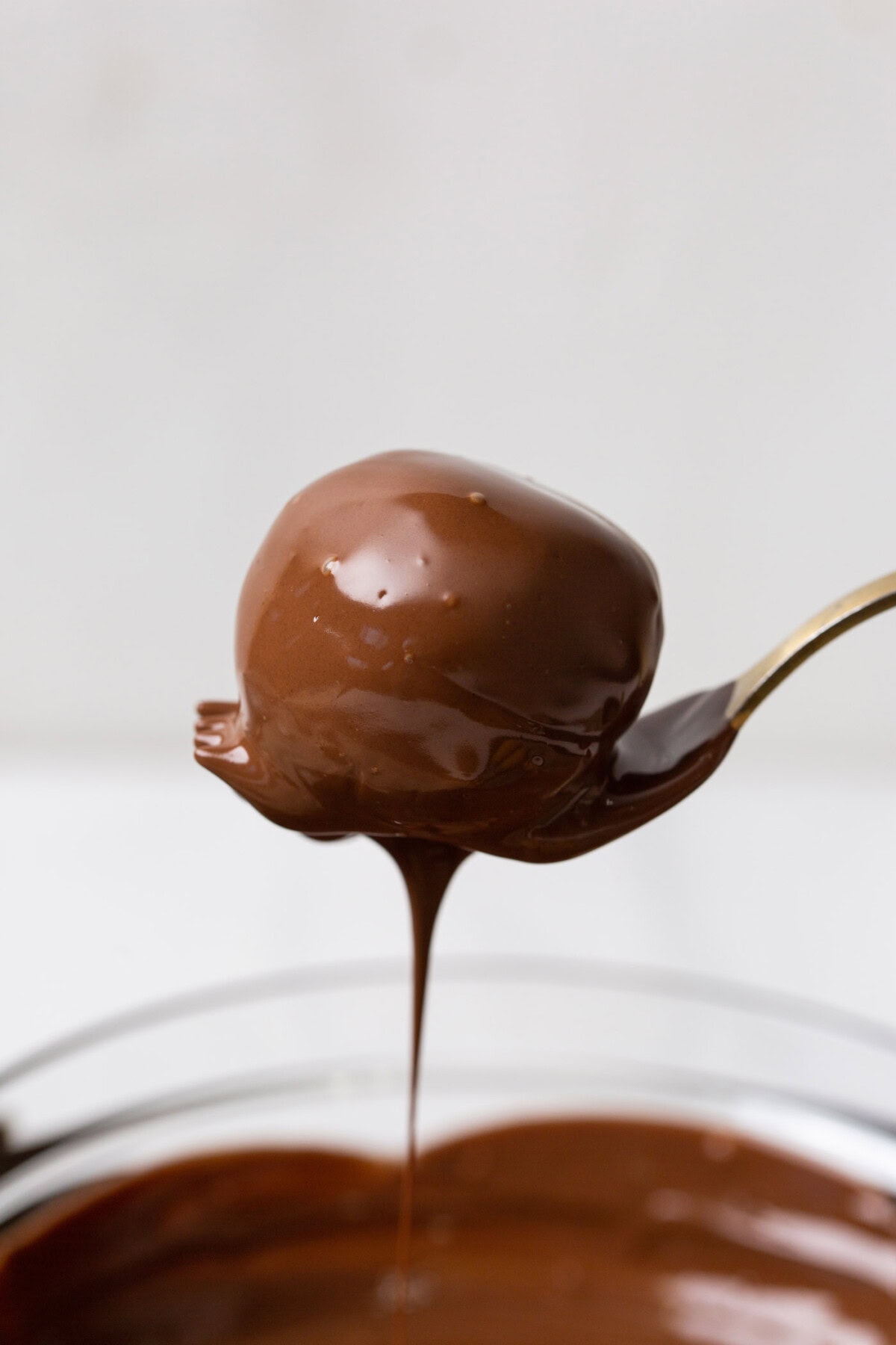 cake ball dipped in chocolate on a fork
