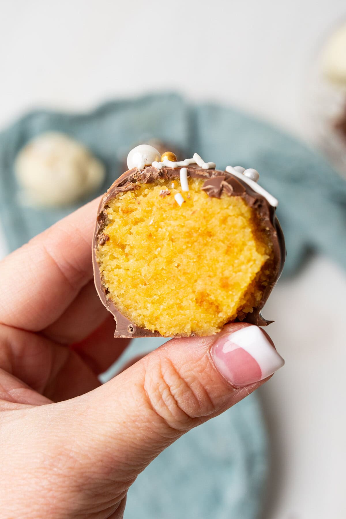 holding half of a cake ball