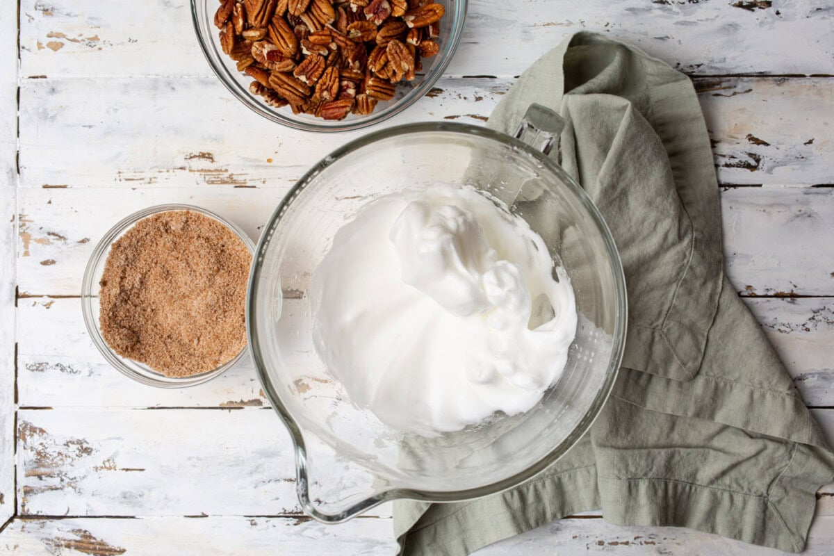 egg whites, water, and vanilla extract whipped in a bowl