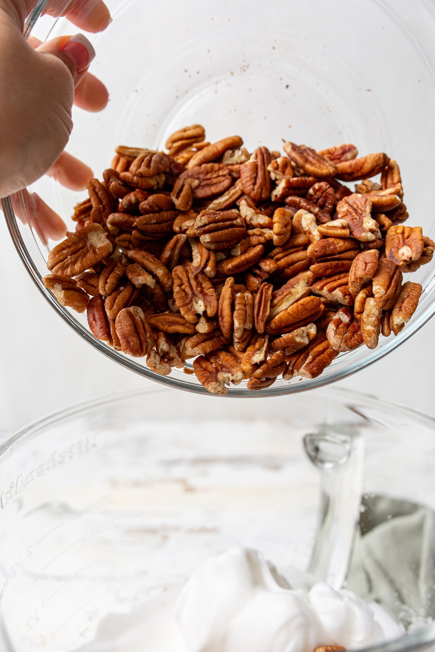 pouring a bowl of pecans