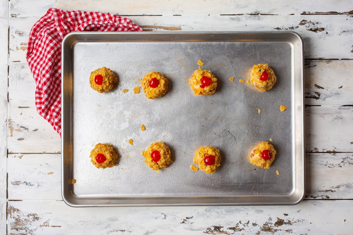 cherry wink cookie dough balls on a baking sheet