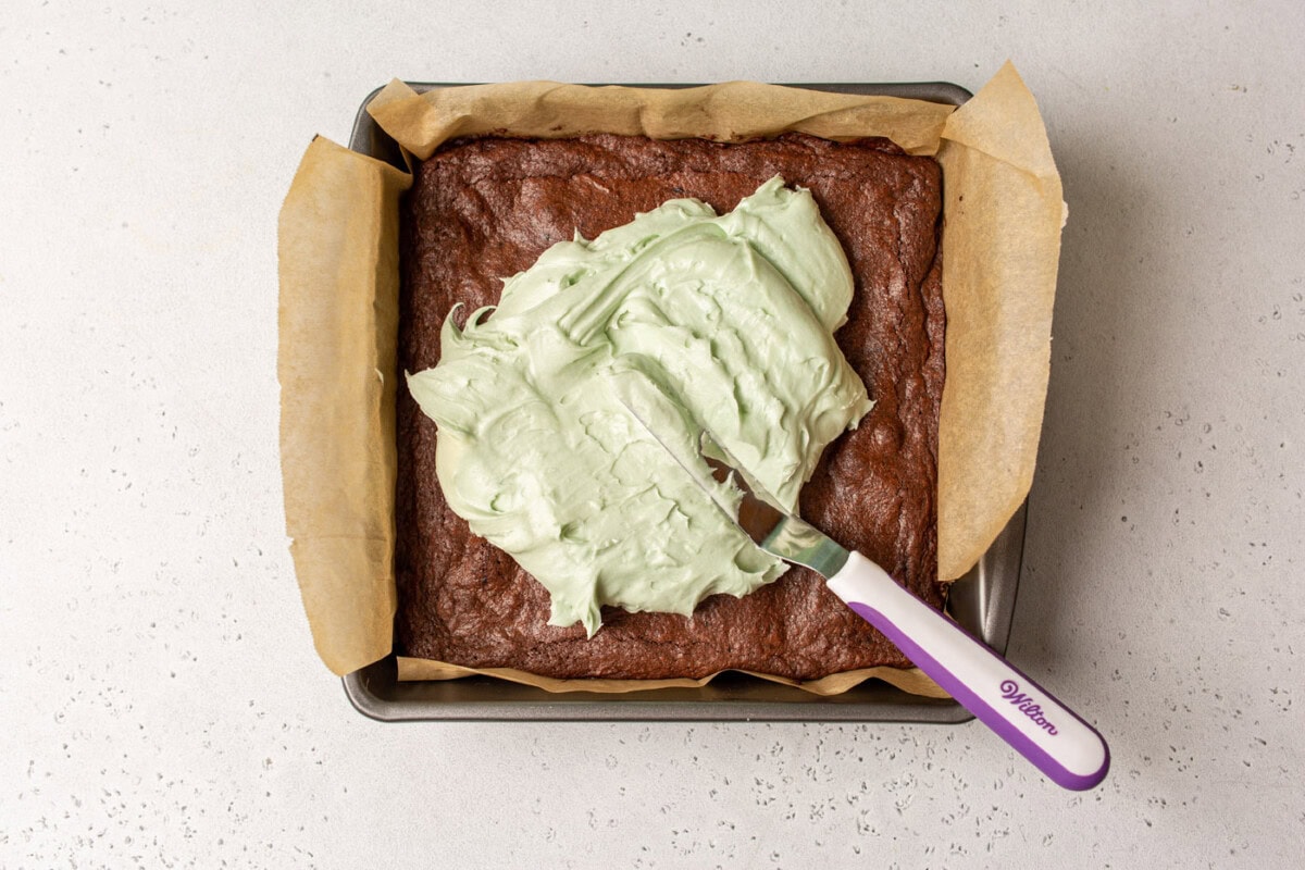 mint frosting spread onto brownies