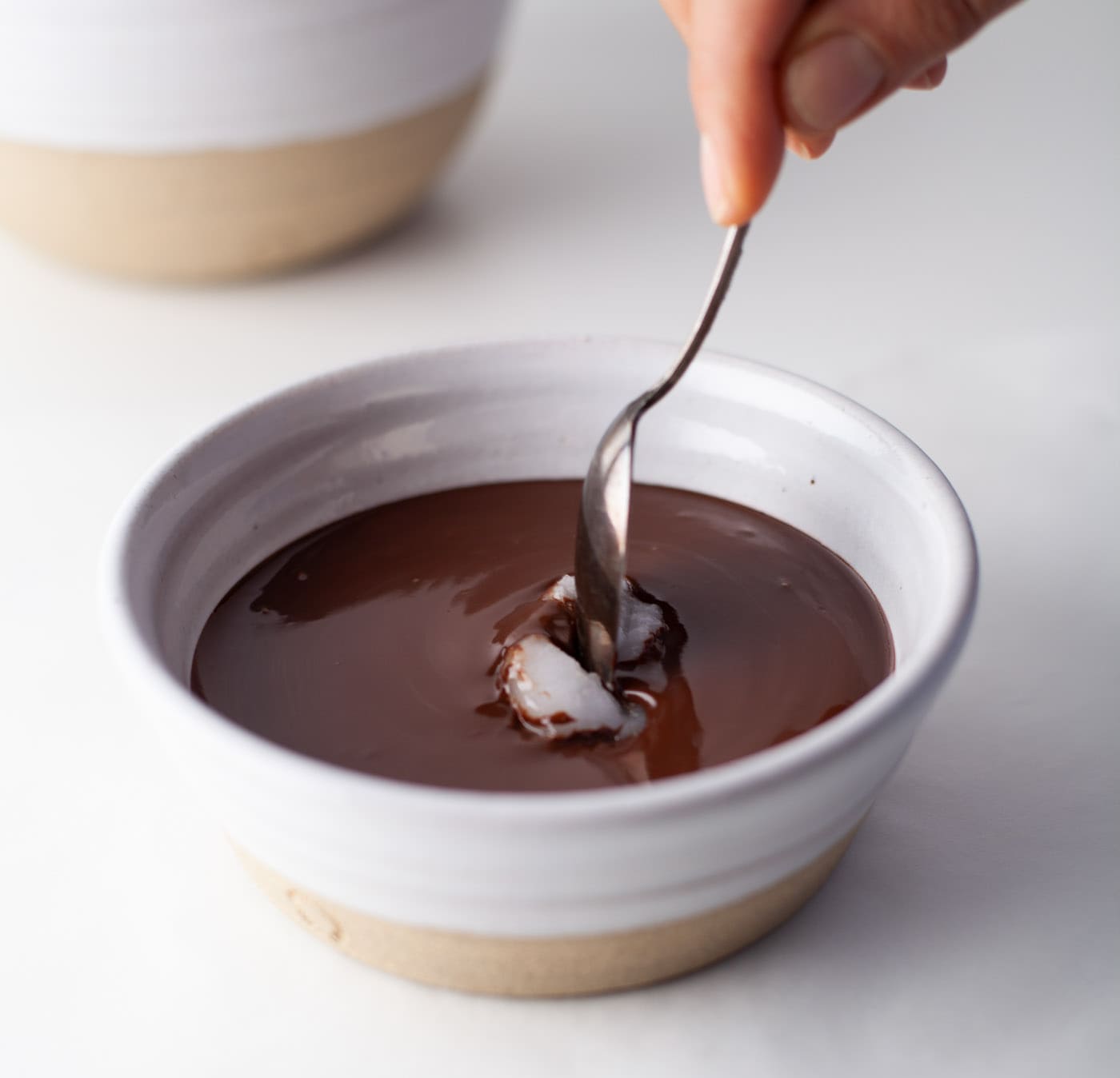 stirring coconut oil into melted chocolate