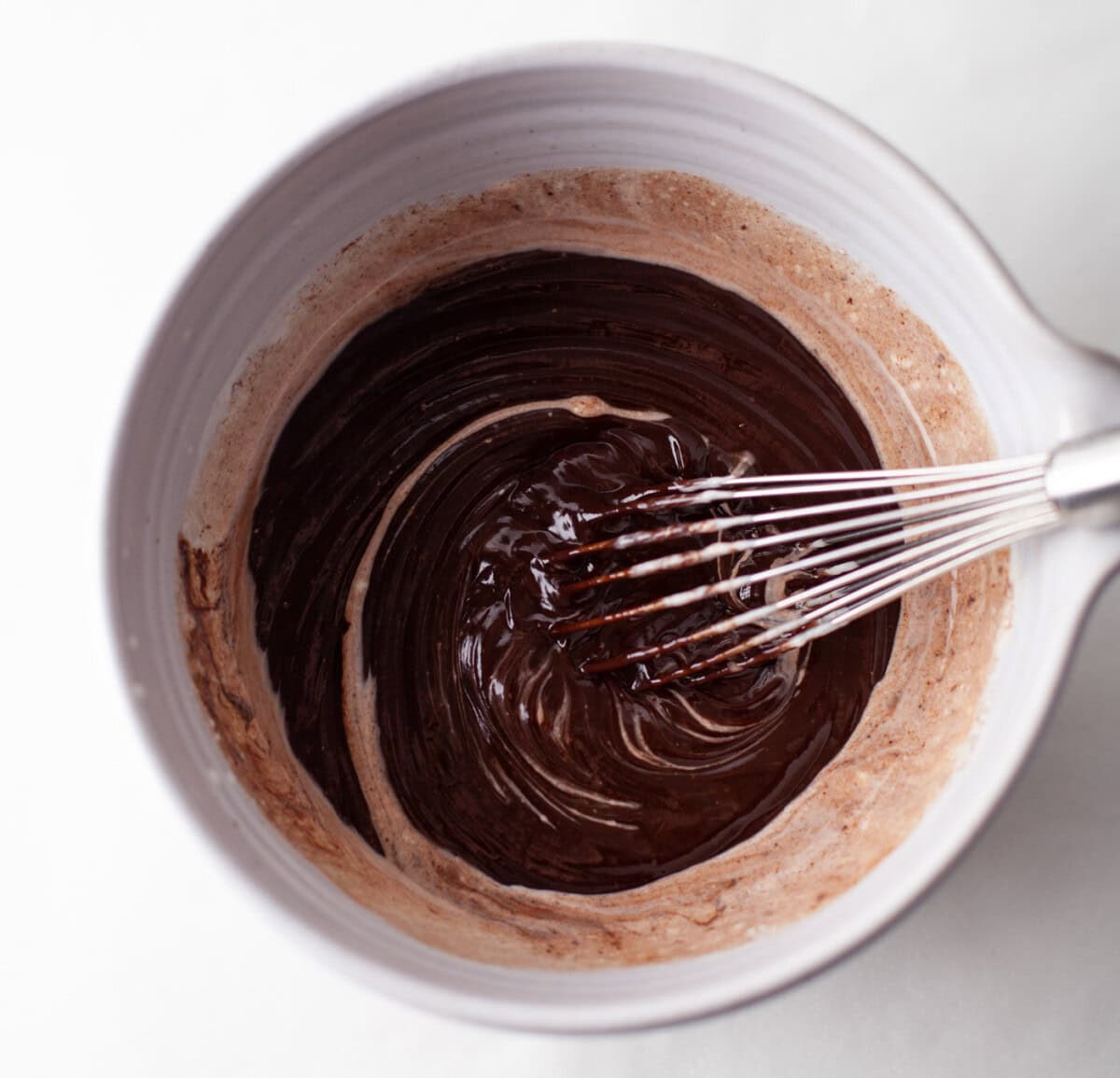 whisking together whipping cream and melted chocolate