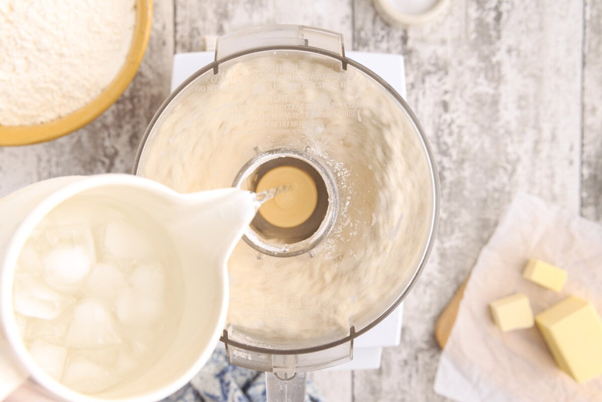 ice water pouring into butter and flour mixture