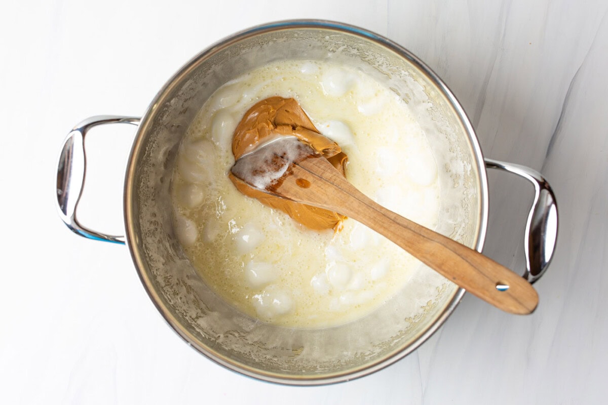 stirring peanut butter into melted butter and marshmallows