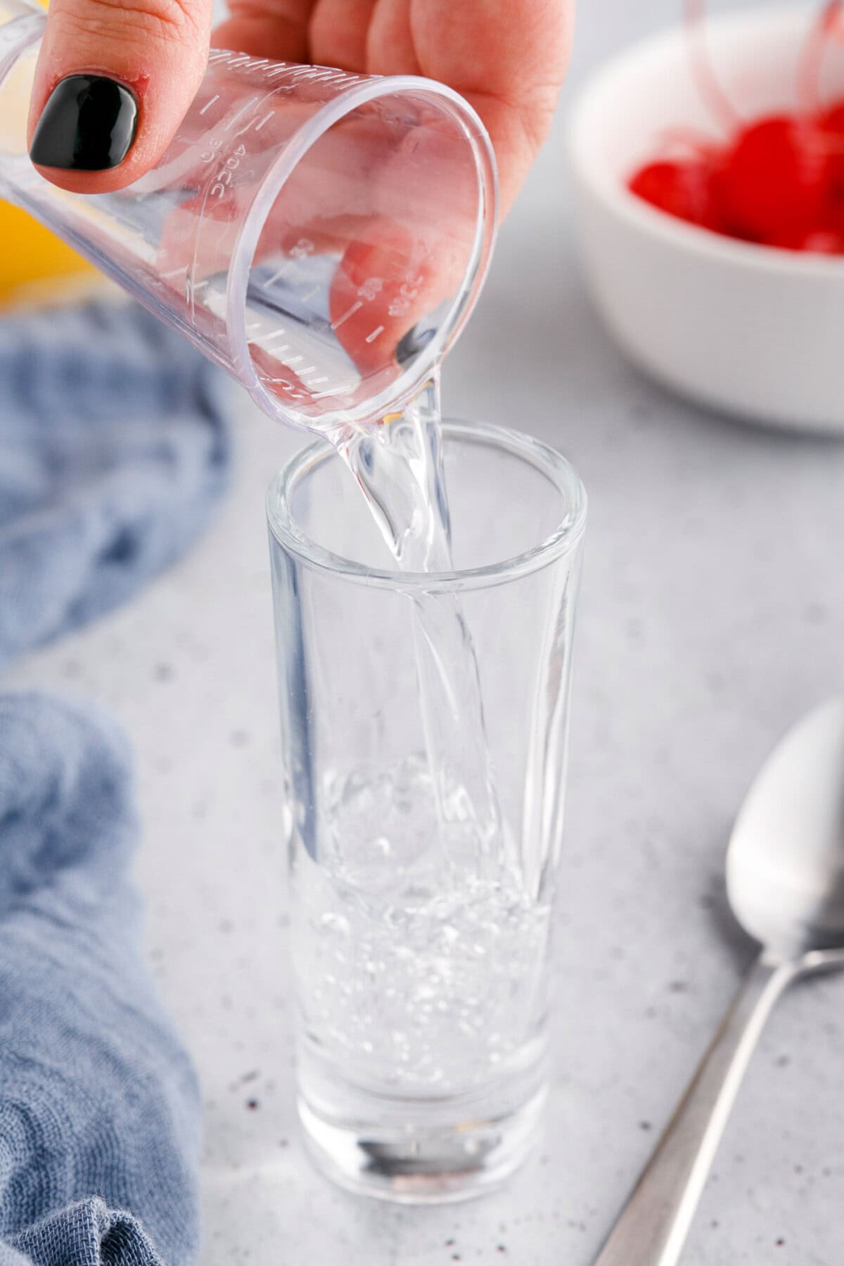 pouring vodka into shot glass