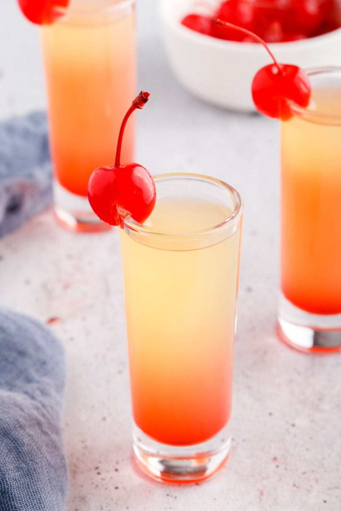 Pineapple Upside Down Cake Shot garnished with a cherry