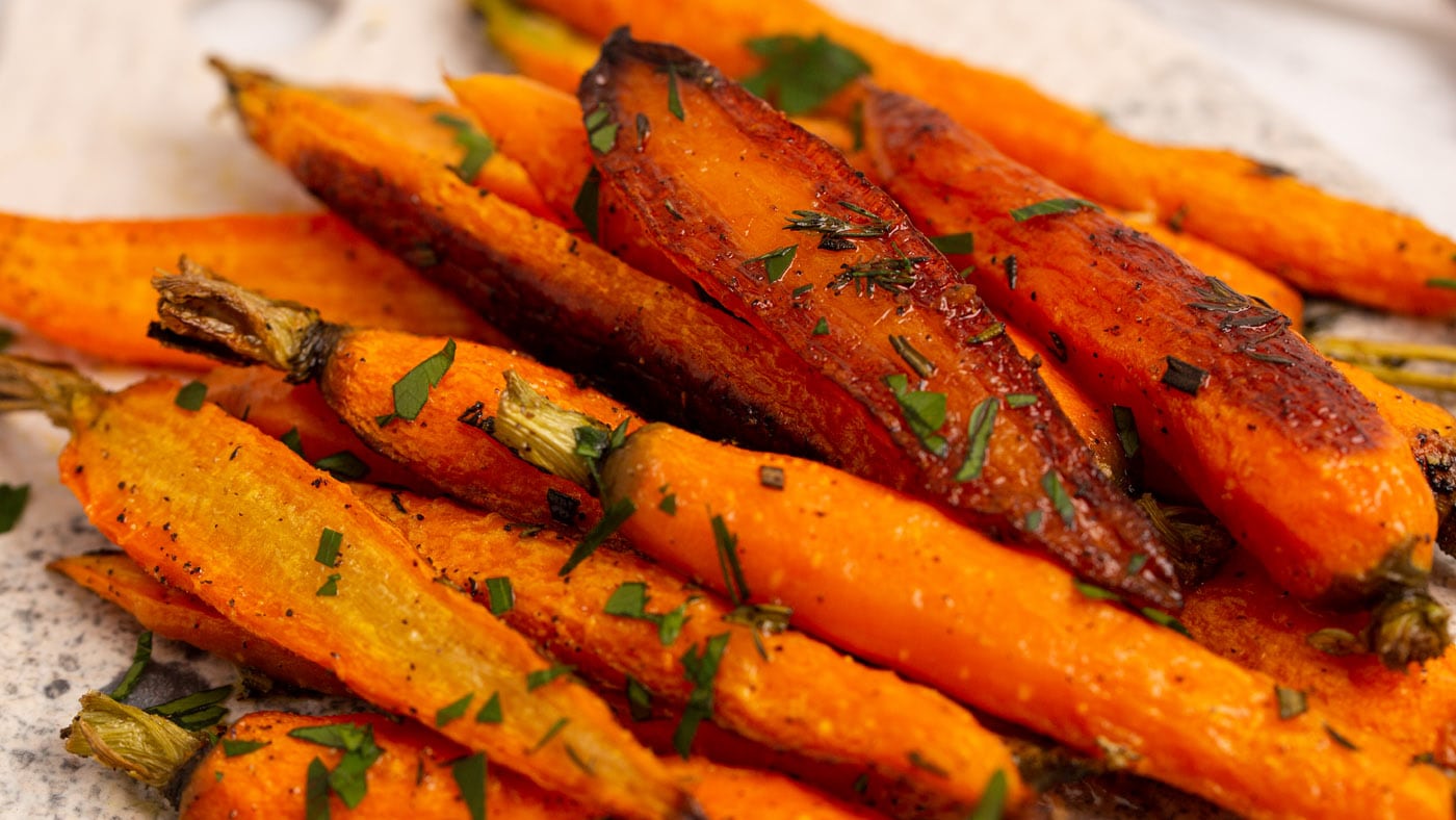 Fresh thyme and rosemary give these roasted carrots a beautiful robust flavor that complements the n