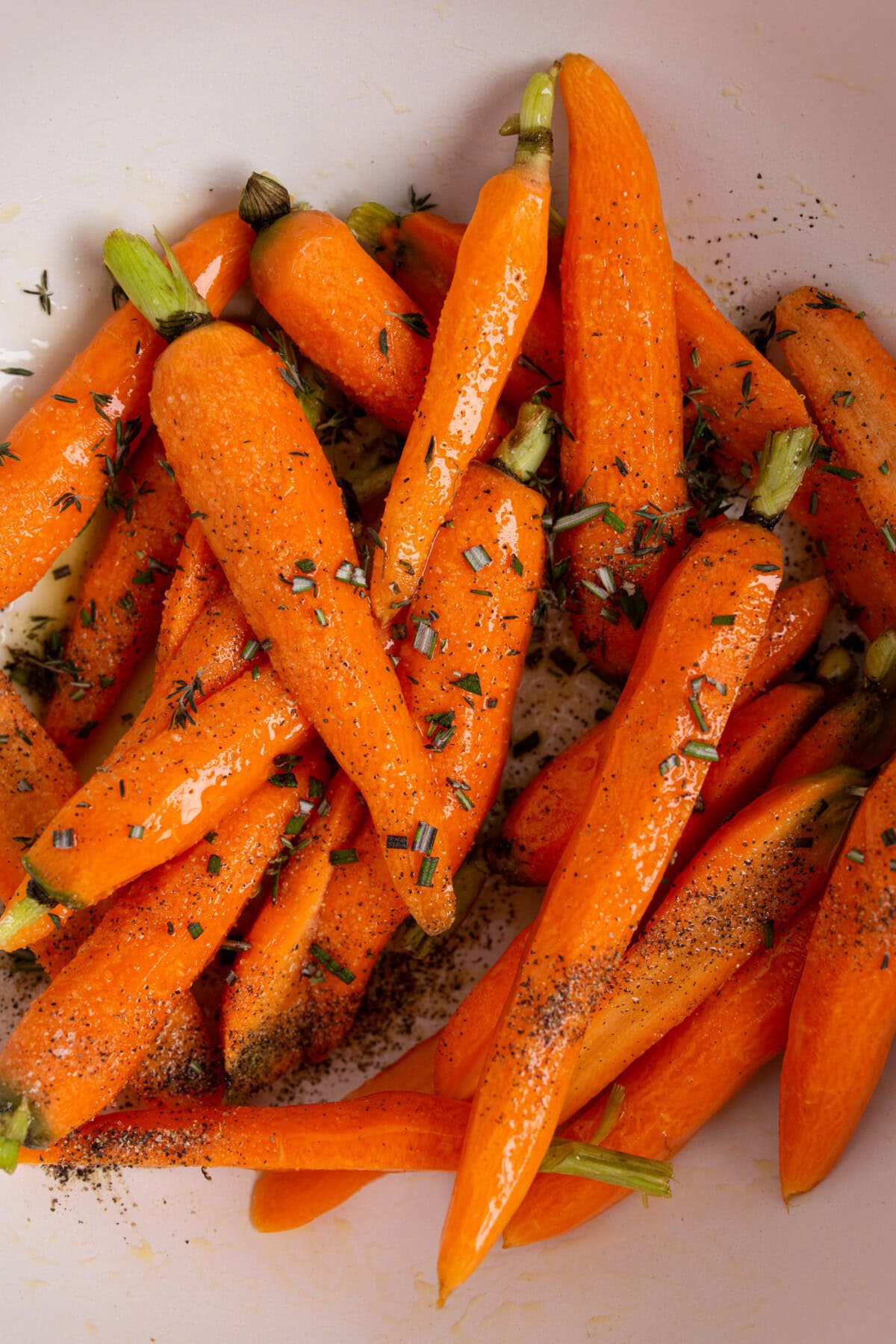 carrots in a bowl with seasonings