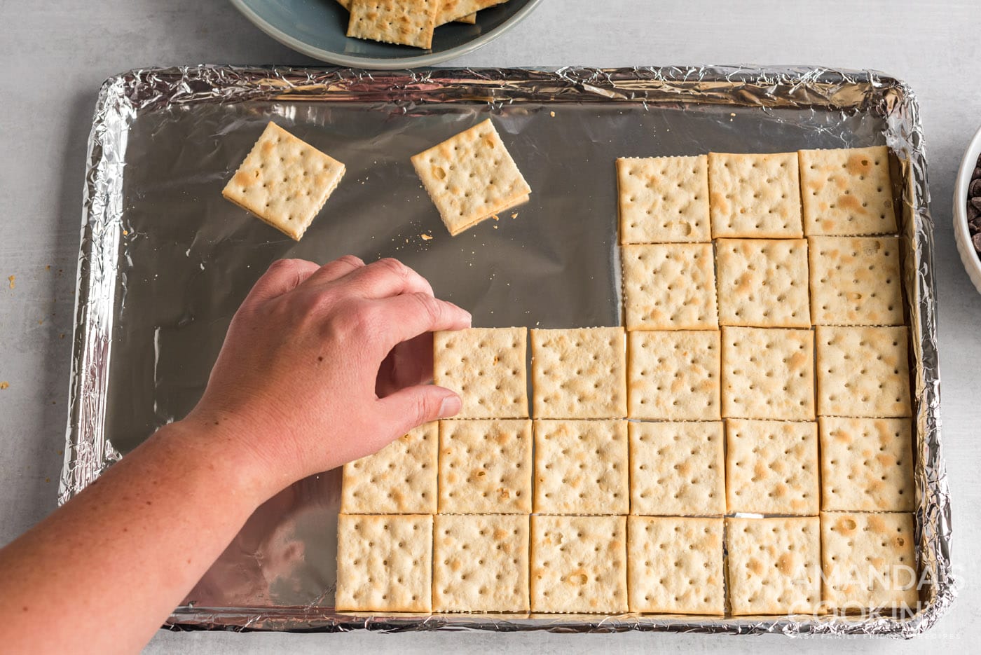 saltine crackers on a baking sheet