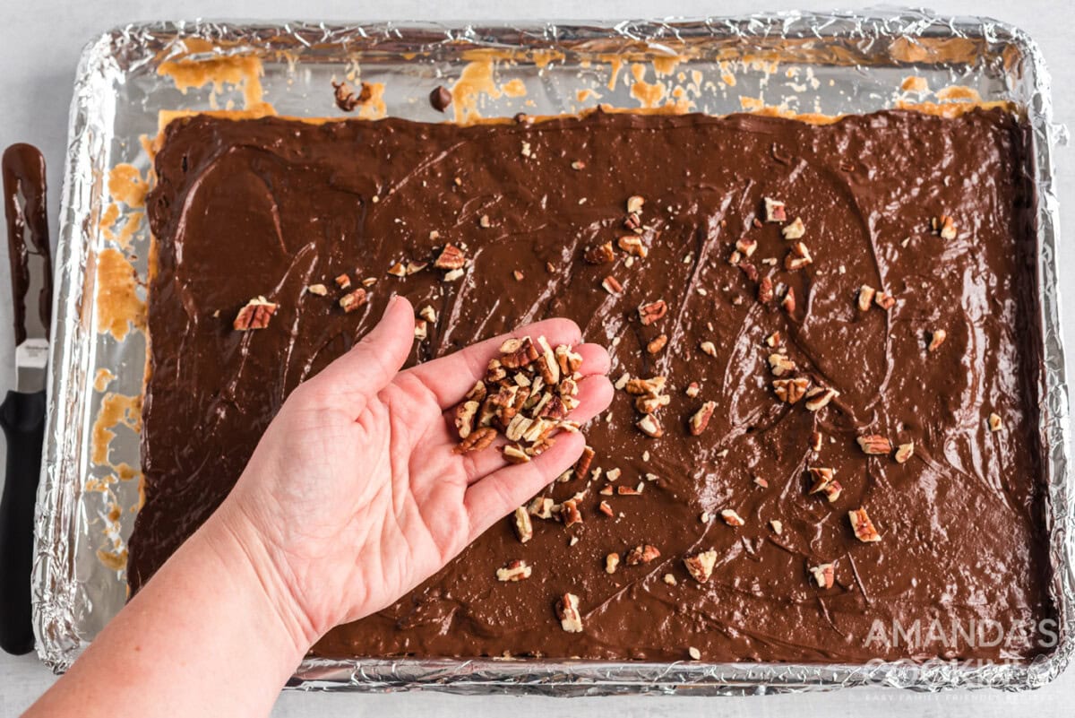 chopped nuts sprinkled on top of saltine toffee
