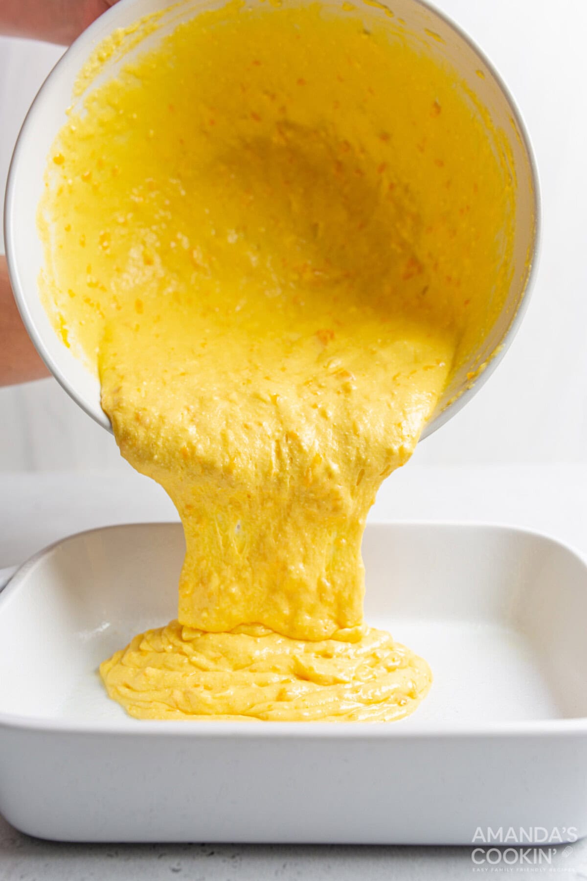 pouring cake mix into pan