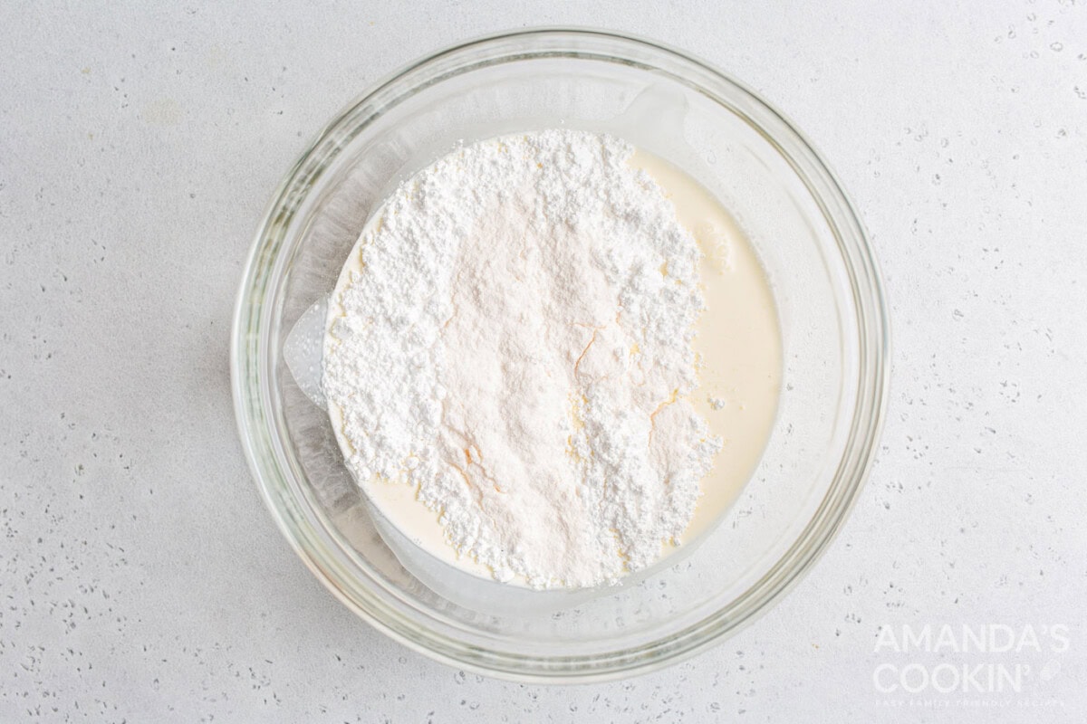 heavy whipping cream, powdered sugar, and vanilla pudding mix in a mixing bowl