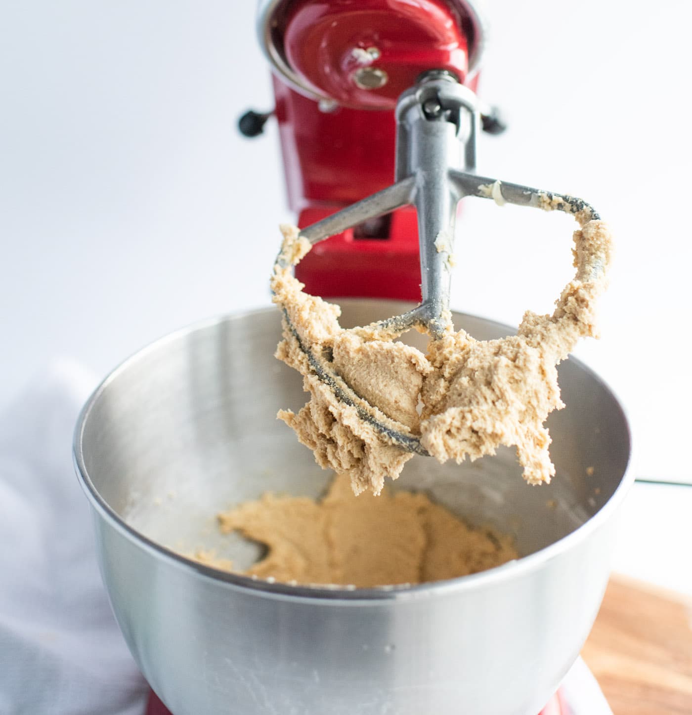 peanut butter cookie dough on paddle attachment in a stand mixer