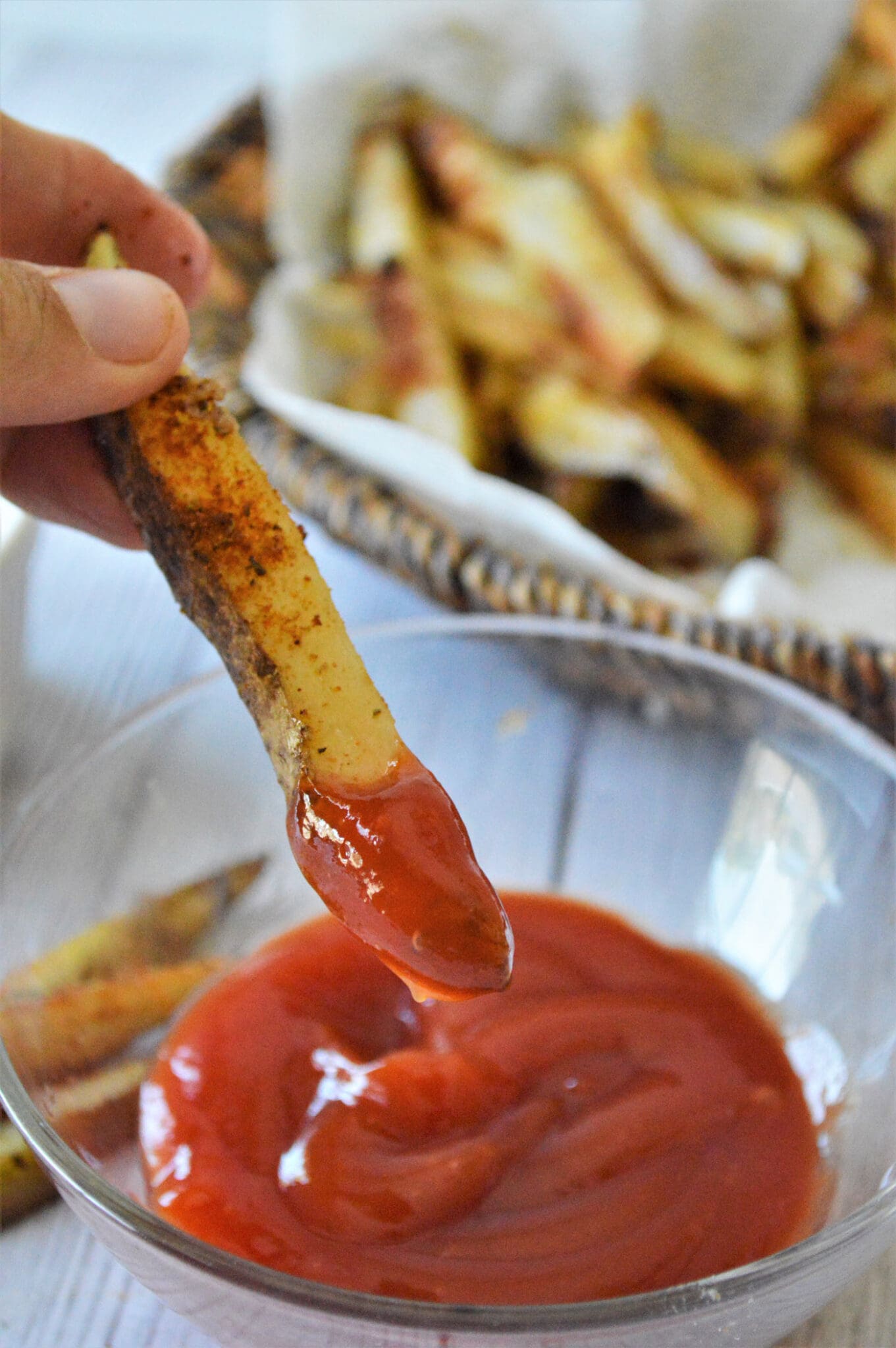 dipping Baked French Fry in ketchup